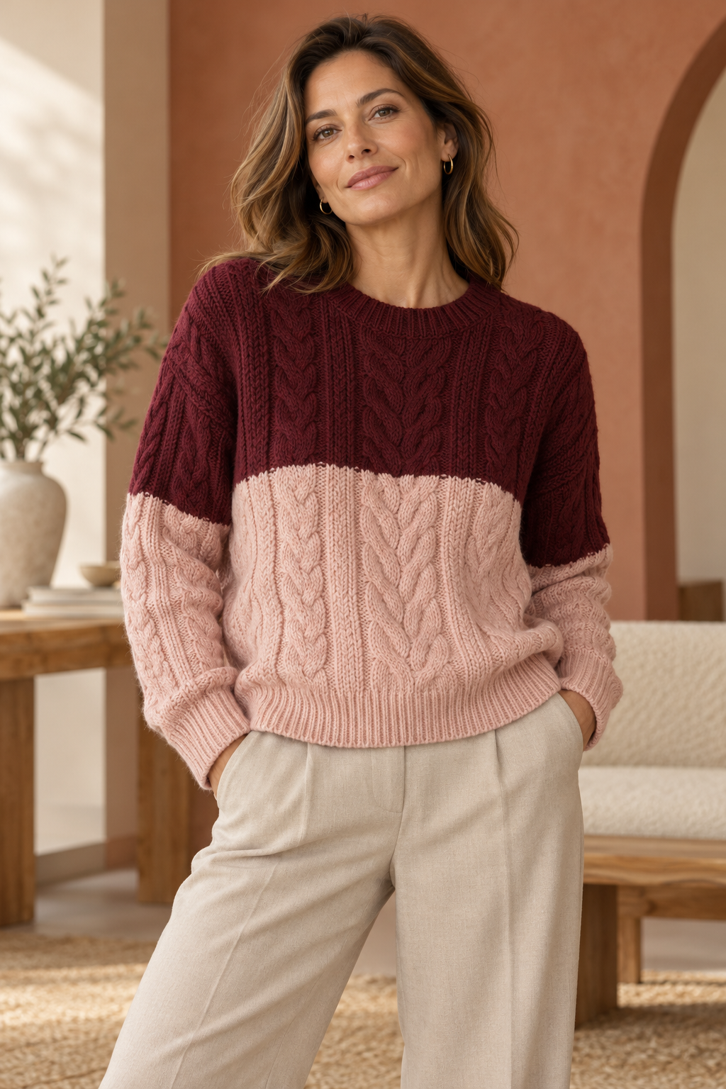 Imagen conceptual de Jersey trenzado burdeos y rosa creada con IA; prenda pendiente de confirmar