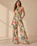Imagen conceptual de Mono floral tropical de cuello halter creada con IA; diseño pendiente de confirmar.
